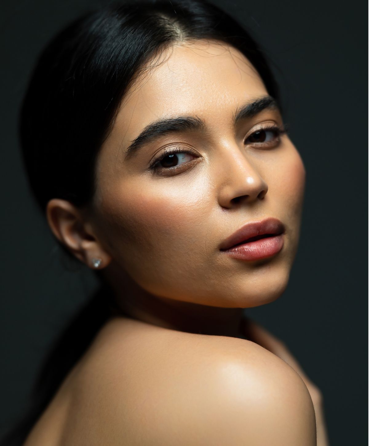 Close-up portrait of a Farmington eyelid surgery model with elegant features.