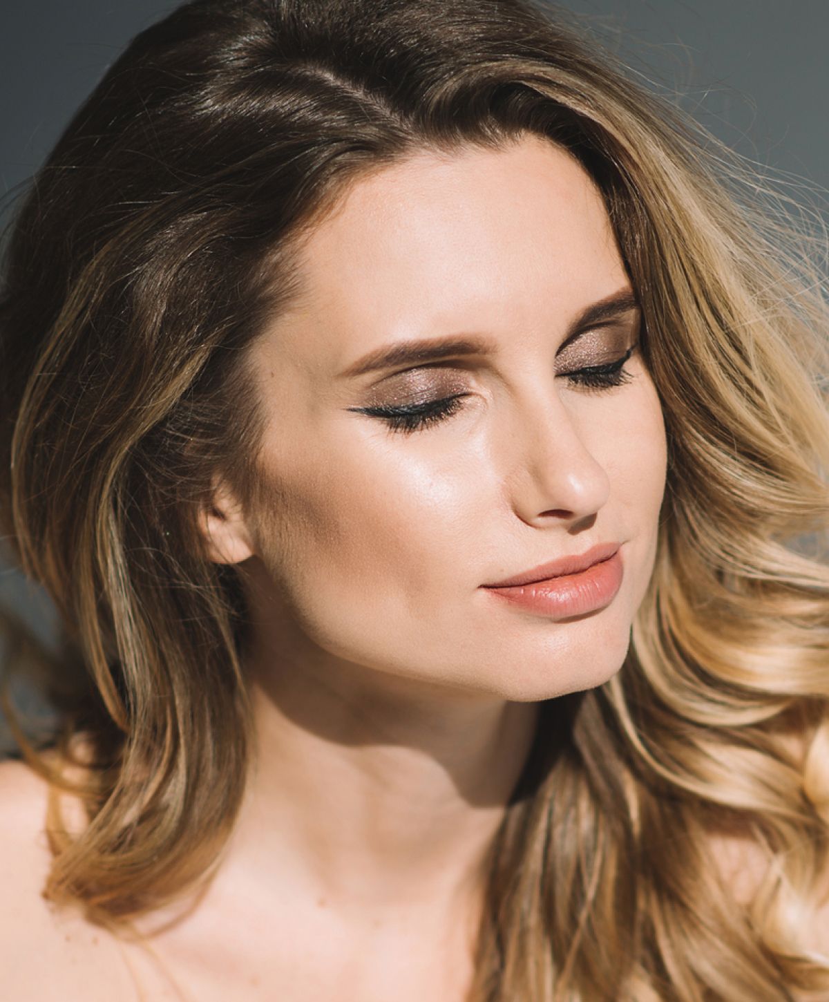 Avon microneedling model with soft makeup and flowing hair.