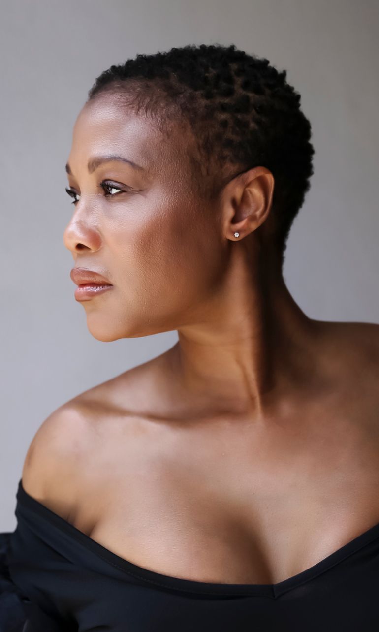 Profile portrait of an Avon plastic surgery model with short hair.