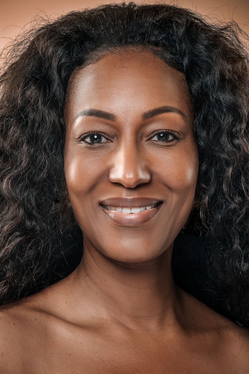 Farmington facelift model with curly hair and glowing skin