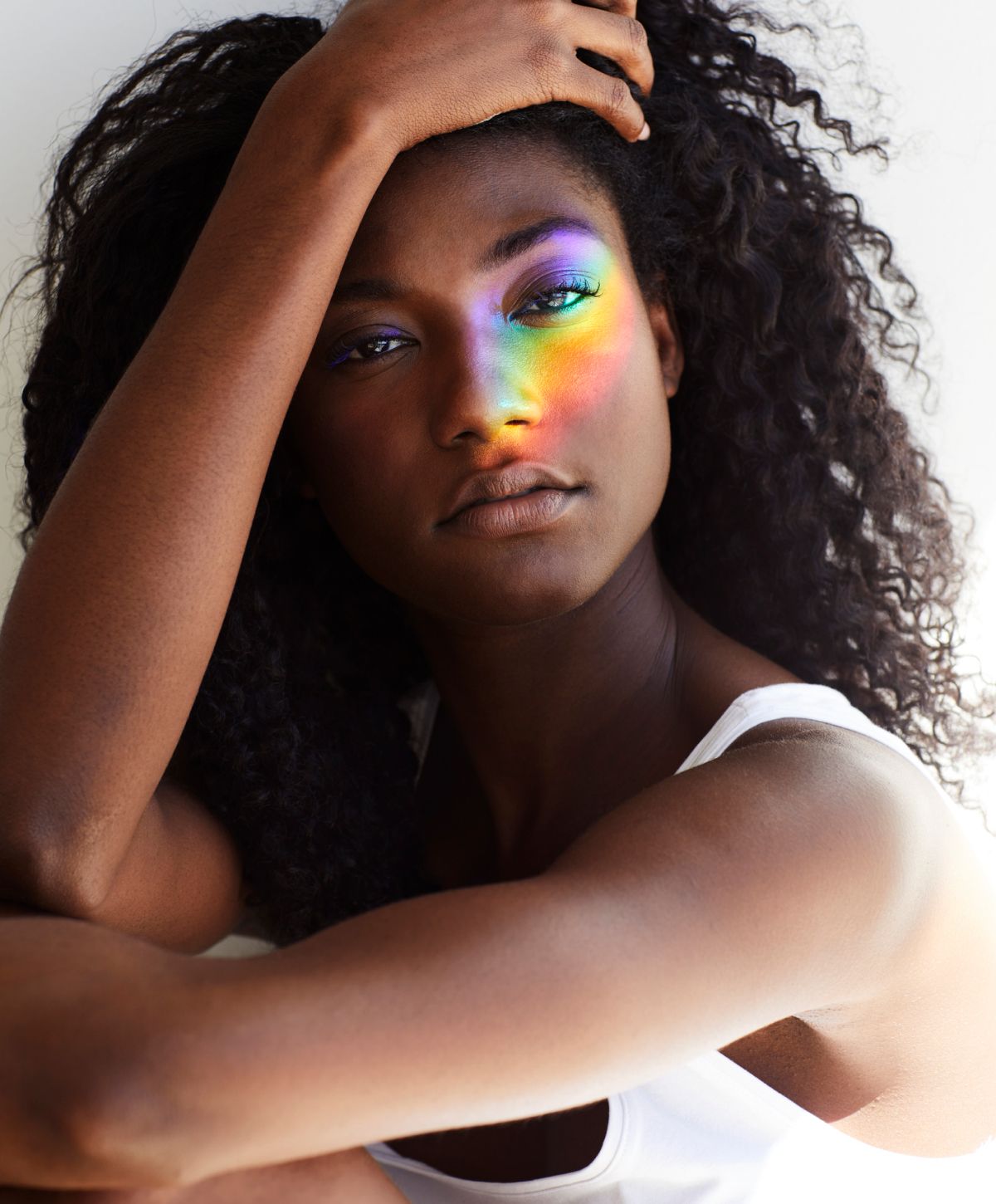 Farmington laser hair removal model with rainbow reflection on cheek.