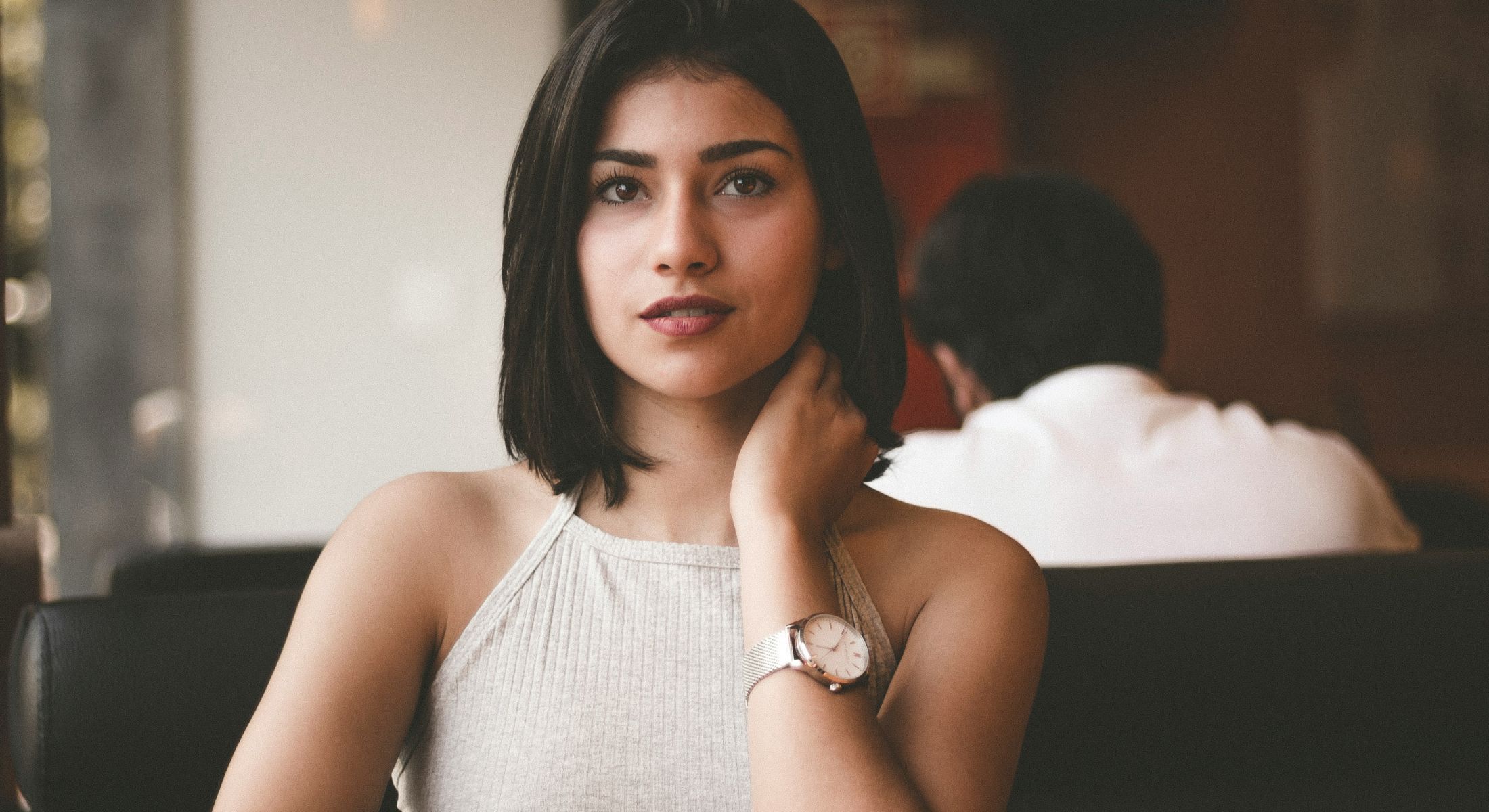 Woman with short hair posing in cafe.
