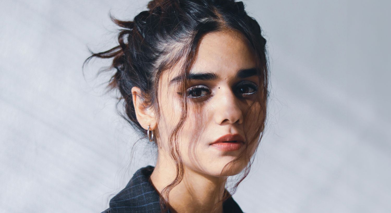 Portrait of a Farmington facial fat transfer model with wavy hair.